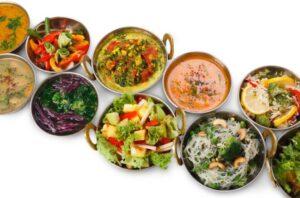 Several vegetarian dishes laid out on a white background