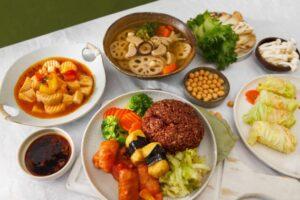 A large spread of vegetarian food on a white table
